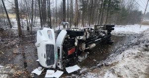 Garbage truck rolls over on icy road in Highgate, driver injured